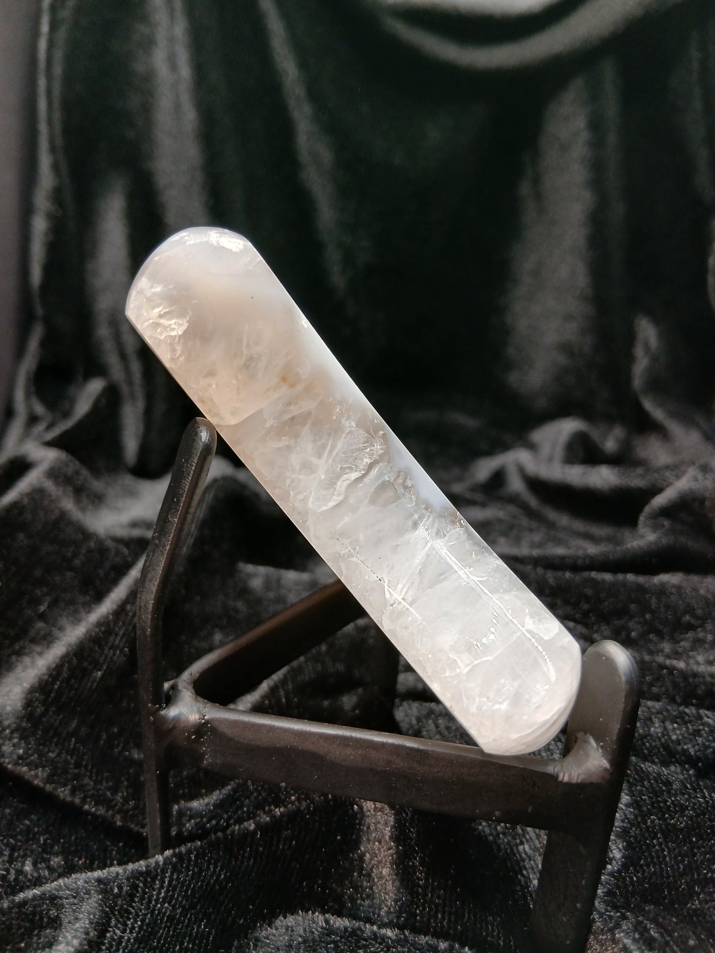 Fordite Haus: Crystals & Fordite agate moon carving with icy white and blue banding, polished finish, and display stand.