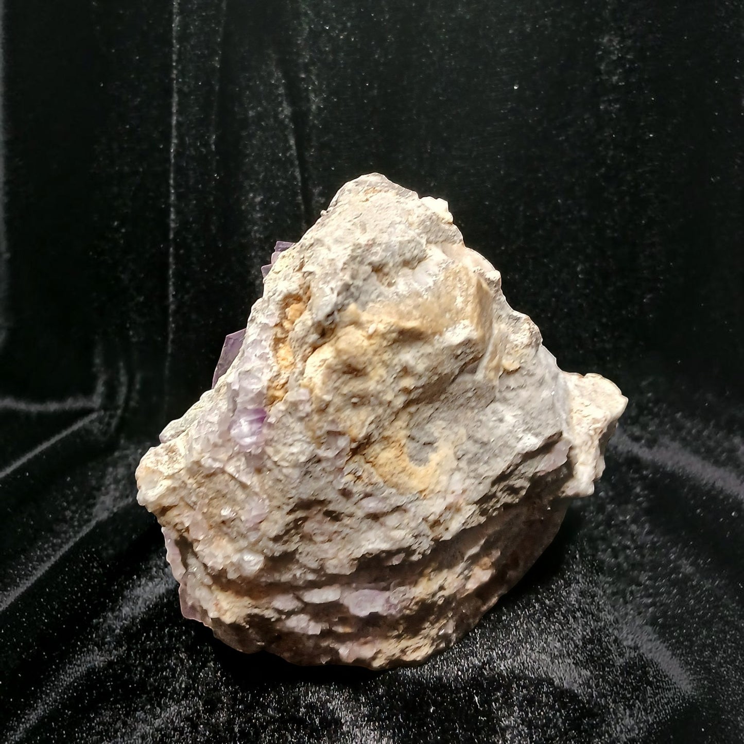 Fordite Haus: Crystals & Fordite purple fluorite mineral specimen from La Viesca Mine with textured rocky matrix