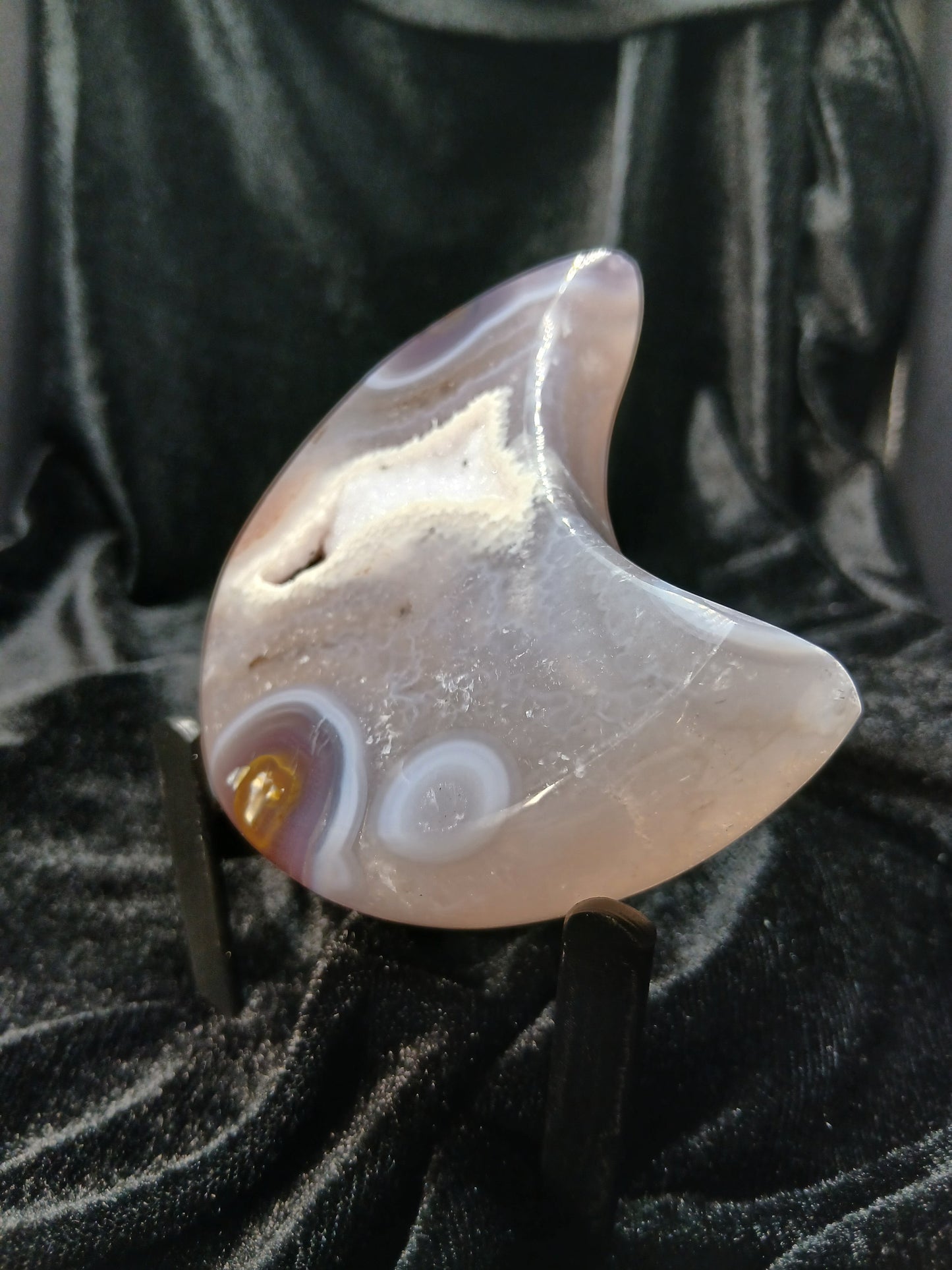 Fordite Haus: Crystals & Fordite polished agate moon carving with natural druzy geode center on a display stand.
