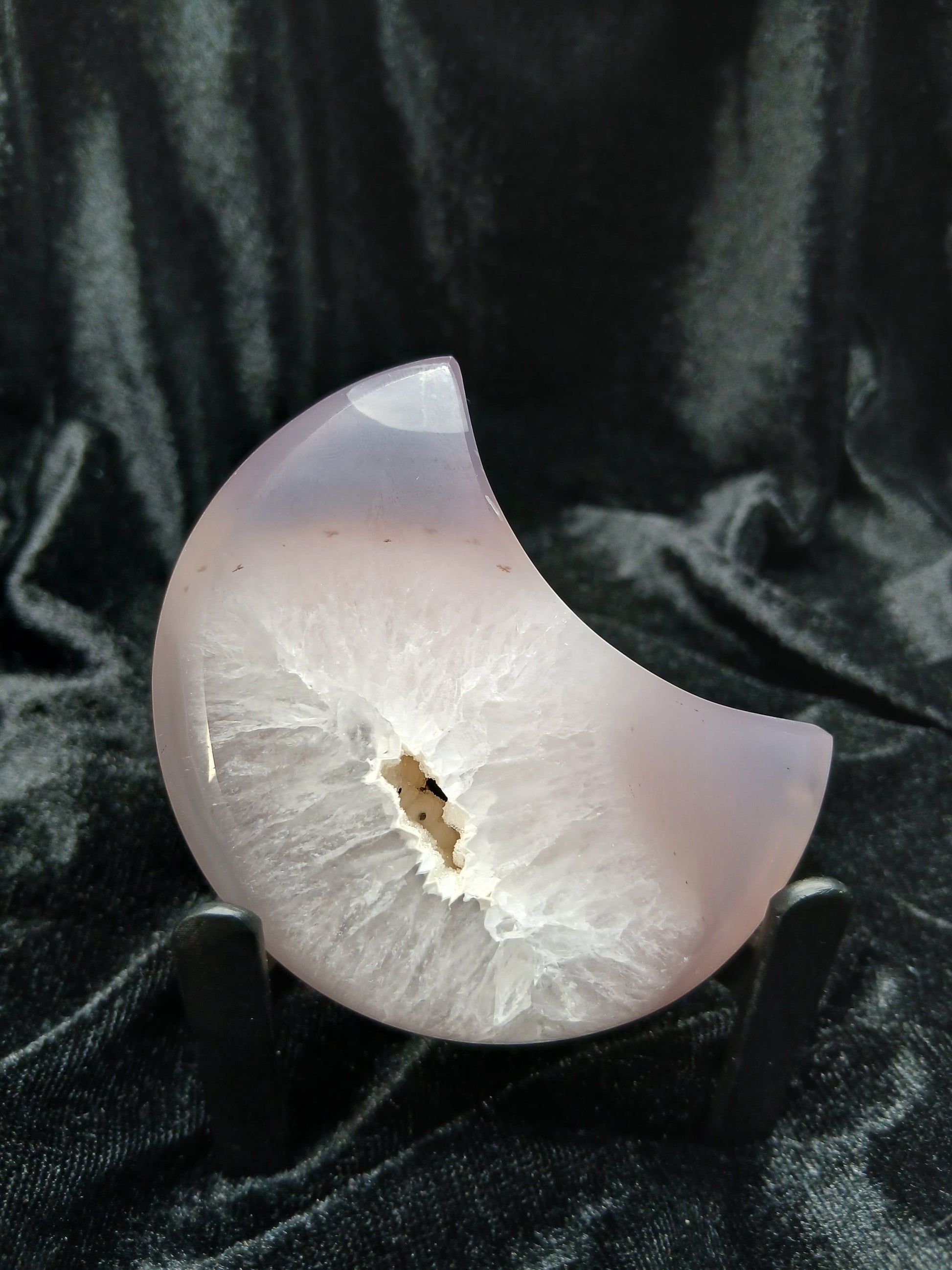 Fordite Haus: Crystals & Fordite lilac-gray agate moon carving with a sparkling white druzy geode center on a display stand