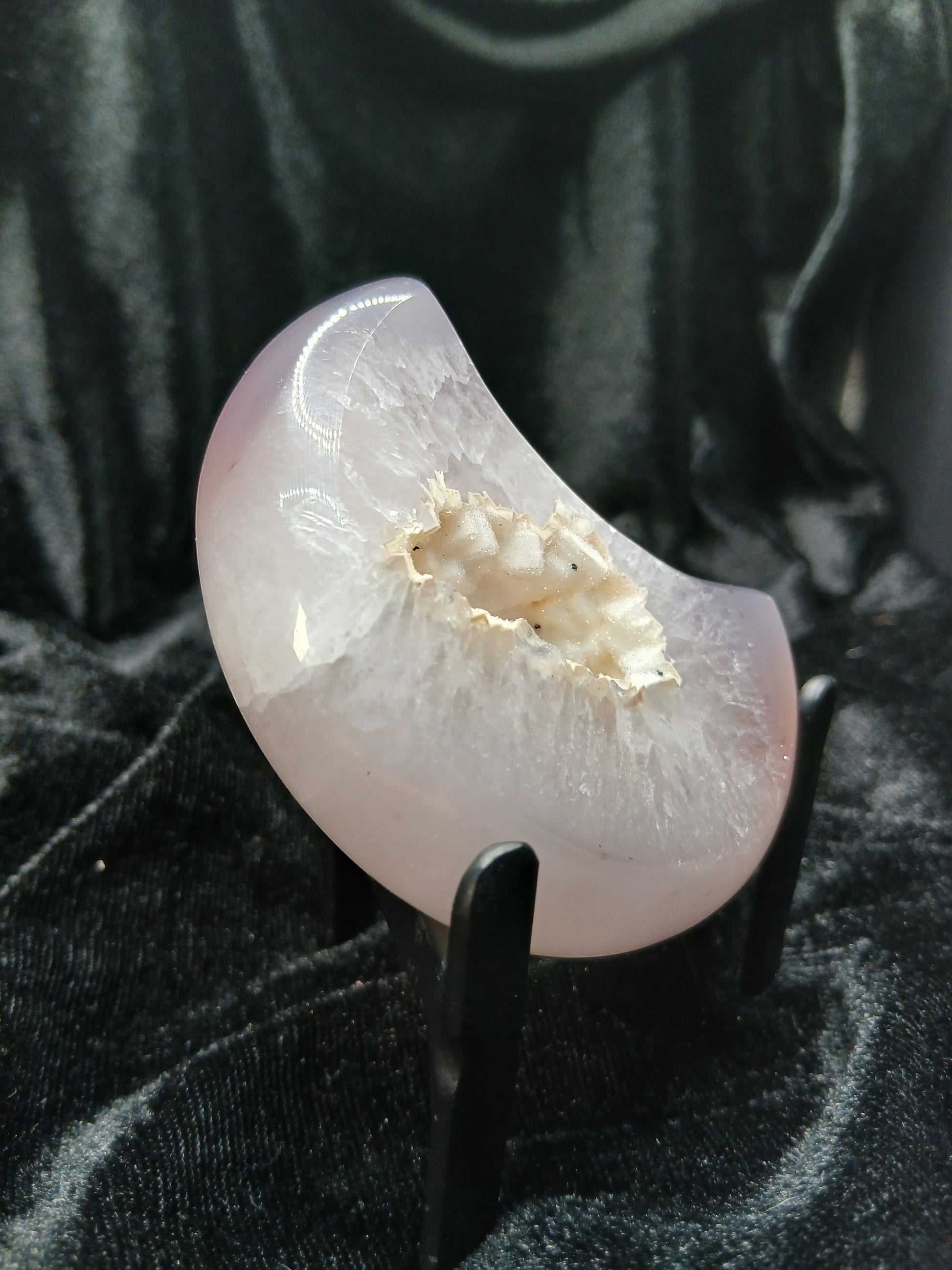 Fordite Haus: Crystals & Fordite lilac-gray agate moon carving with a sparkling white druzy geode center on a stand.