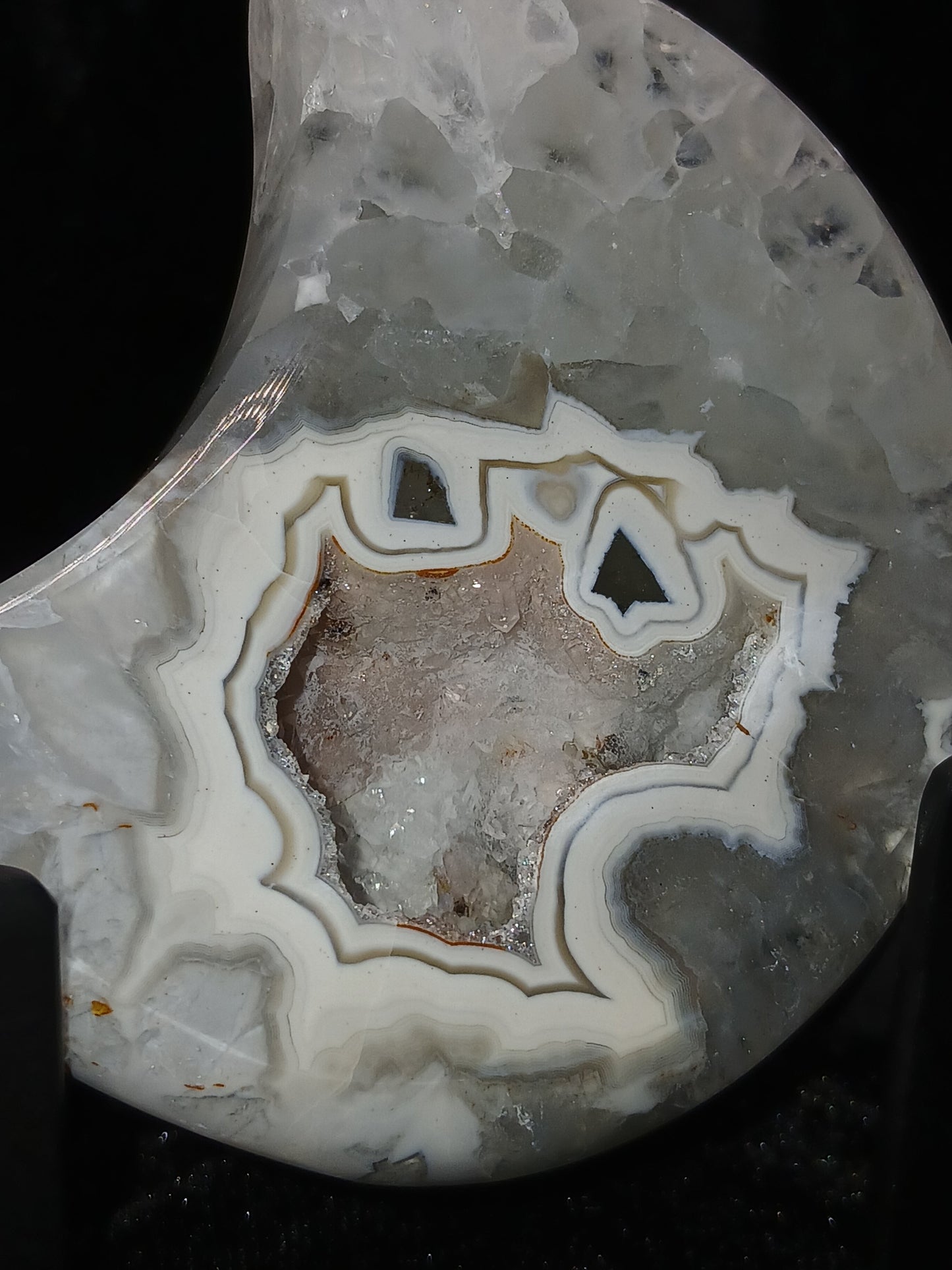 Fordite Haus: Crystals & Fordite 3-inch agate moon carving with white banding and a central druzy crystal geode