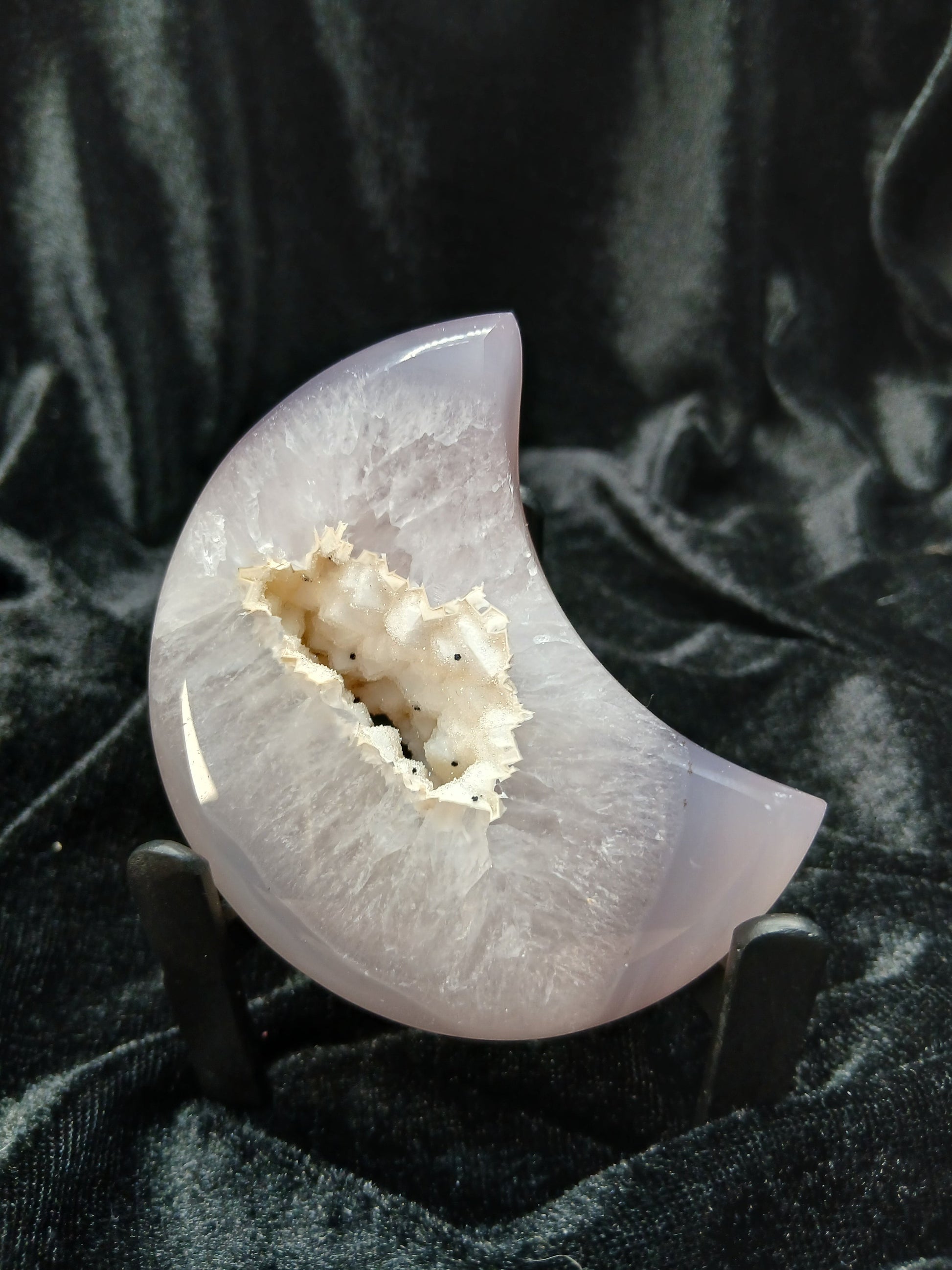 Fordite Haus: Crystals & Fordite lilac-gray agate moon carving with a white druzy geode center on a display stand.