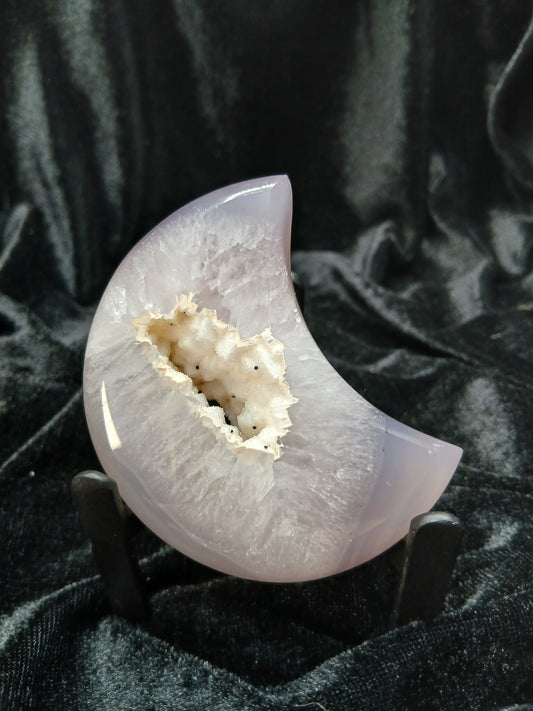 Fordite Haus: Crystals & Fordite lilac-gray agate moon carving with a white druzy geode center on a display stand.