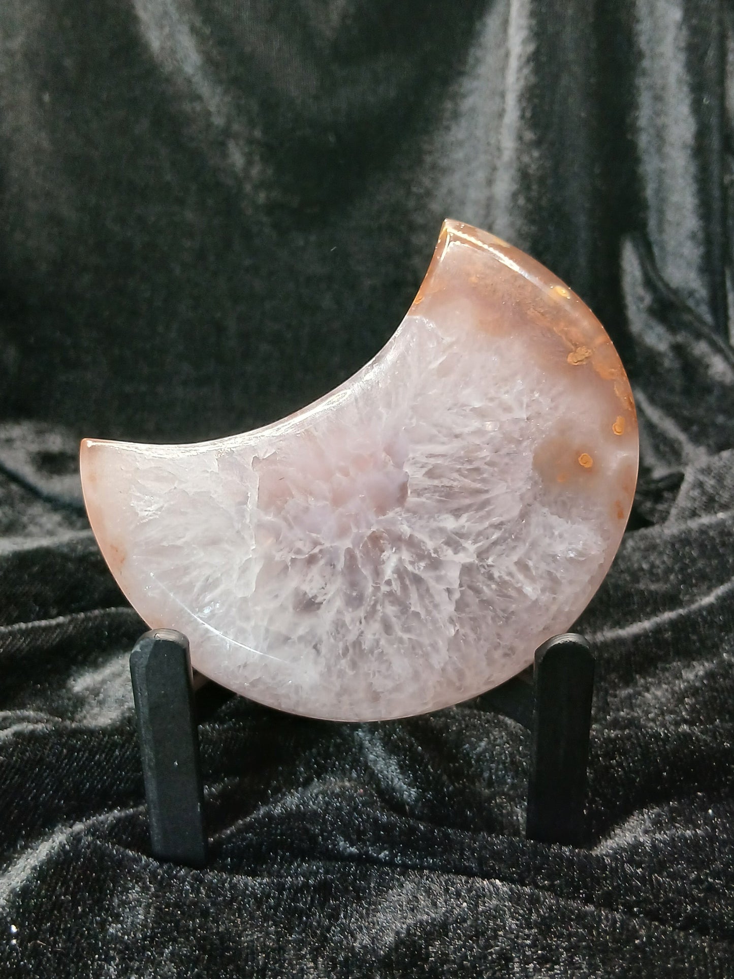 Fordite Haus: Crystals & Fordite agate moon carving with druzy texture on a black display stand