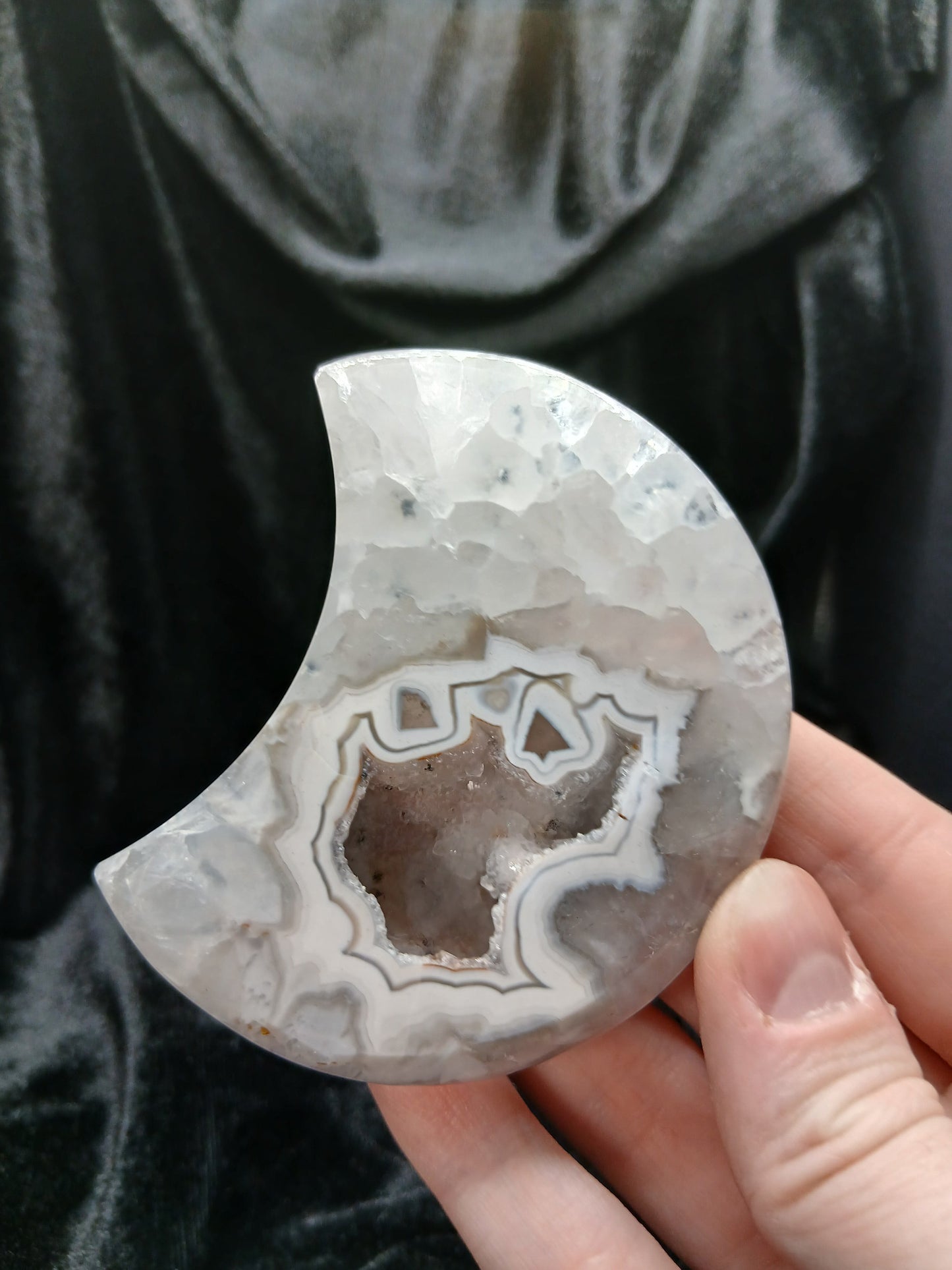 Fordite Haus: Crystals & Fordite 3-inch agate moon carving with natural crystal druzy center and banded patterns