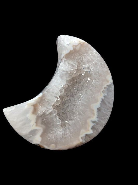 Fordite Haus: Crystals & Fordite agate moon carving with a sparkling druzy crystal center on a black display stand