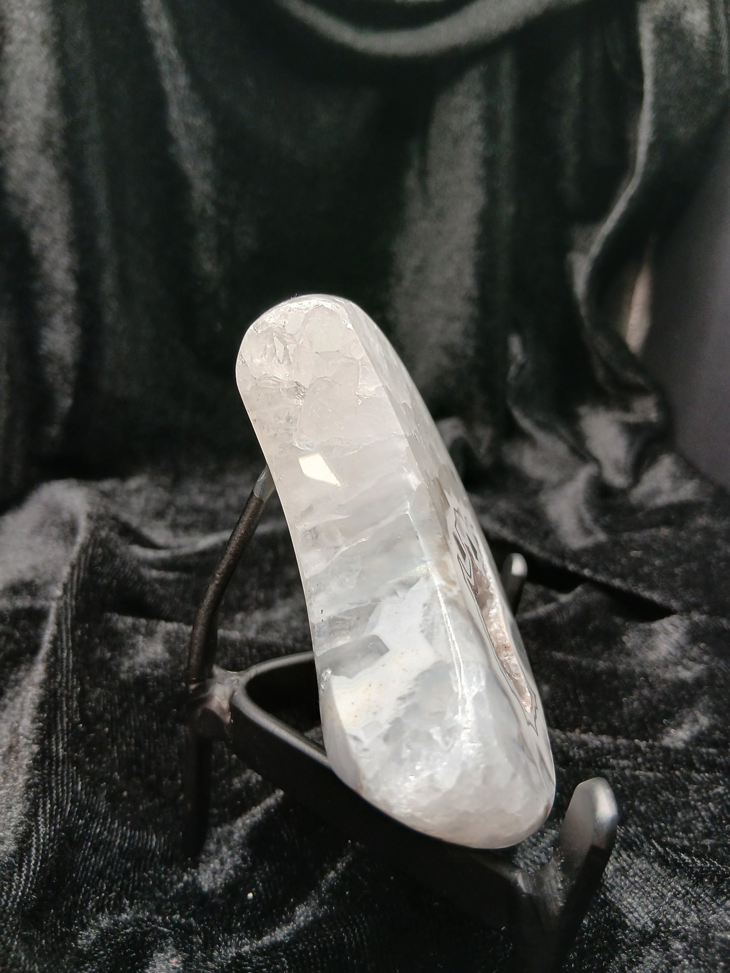 Fordite Haus: Crystals & Fordite 3-inch translucent agate moon carving displayed on a black metal stand