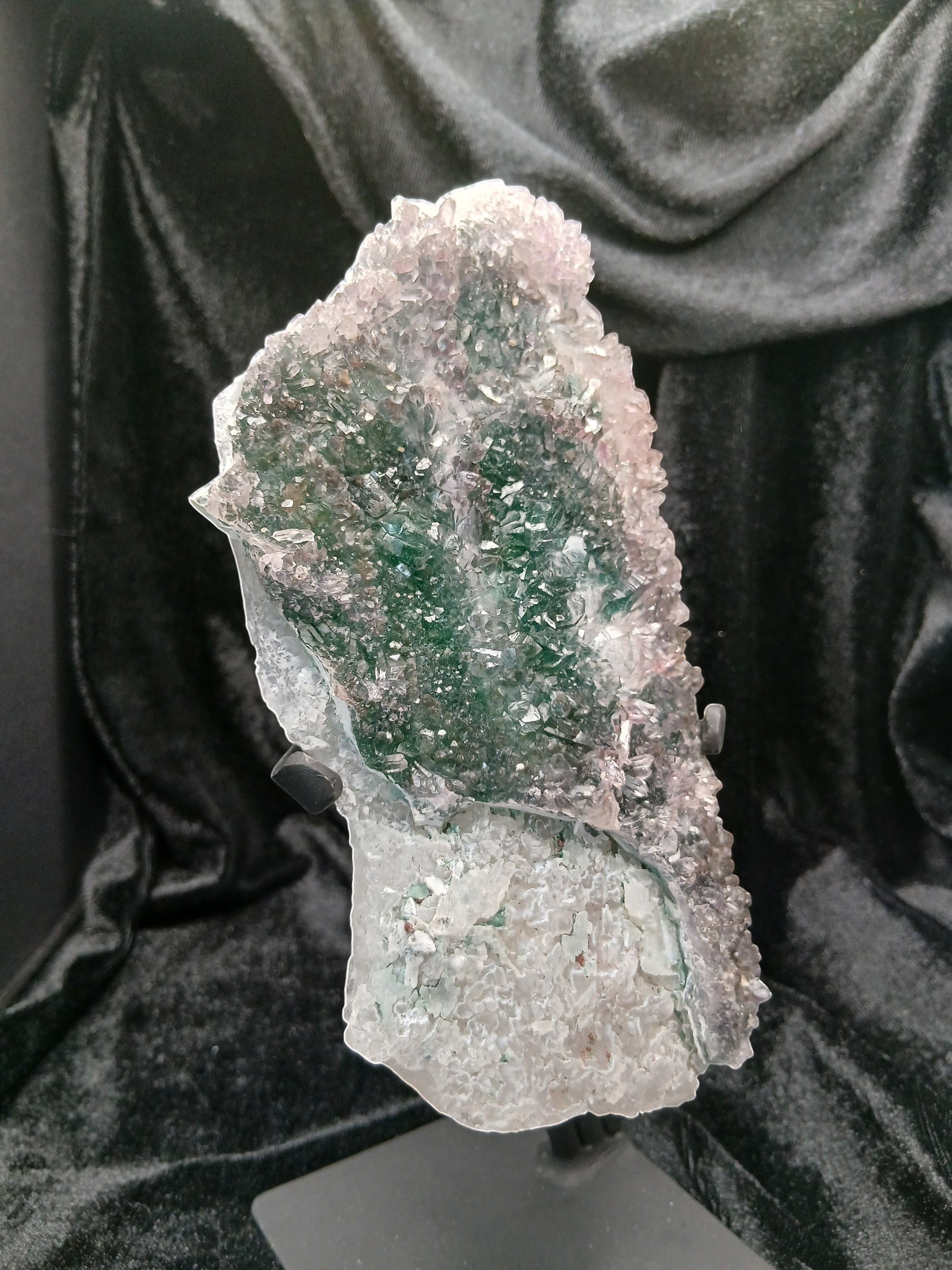 Fordite Haus: Crystals & Fordite green chalcedony and lavender amethyst flower crystal specimen on a black display stand.