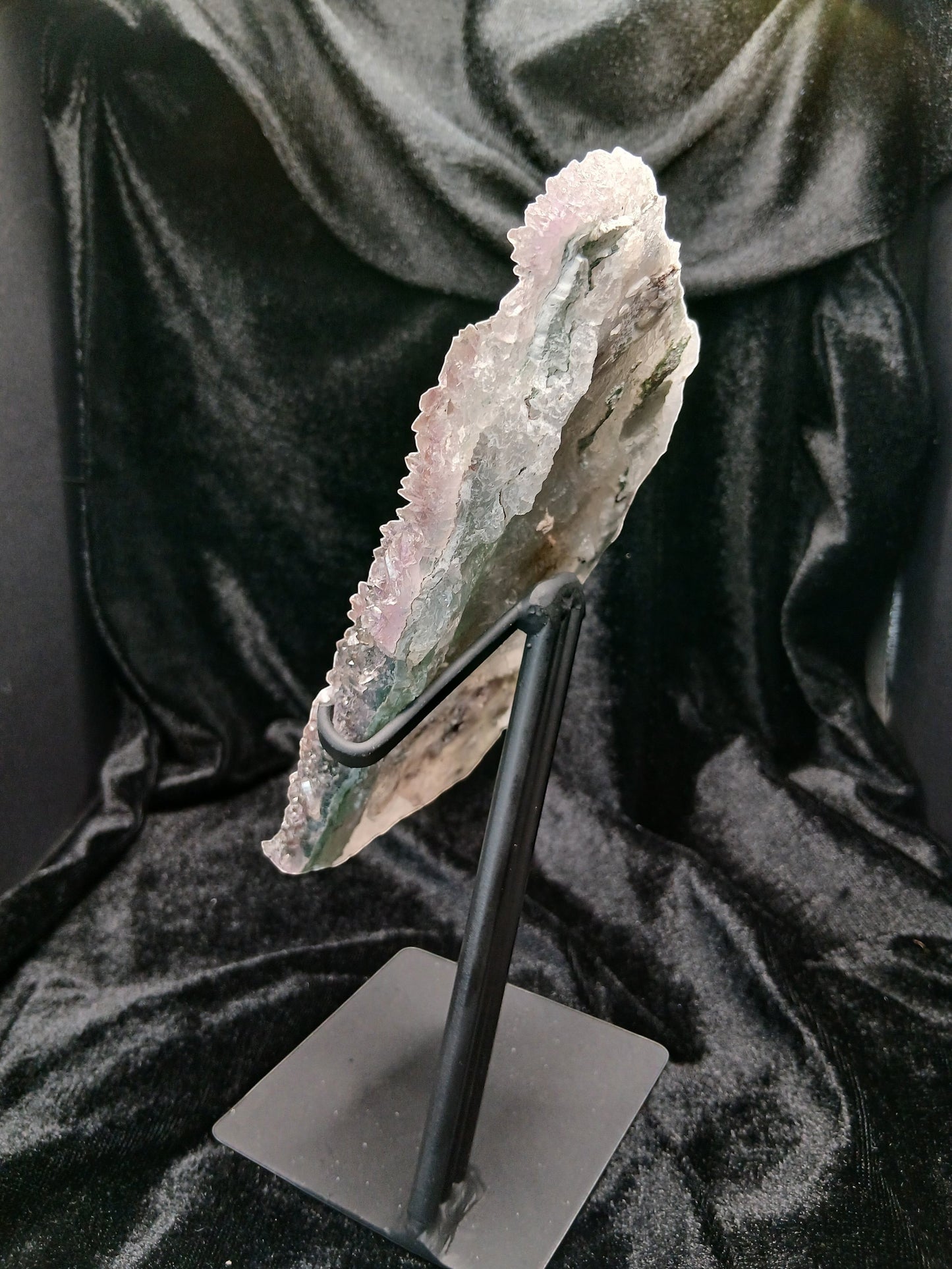 Fordite Haus: Crystals & Fordite green chalcedony and lavender amethyst flower crystal specimen on a black metal stand.