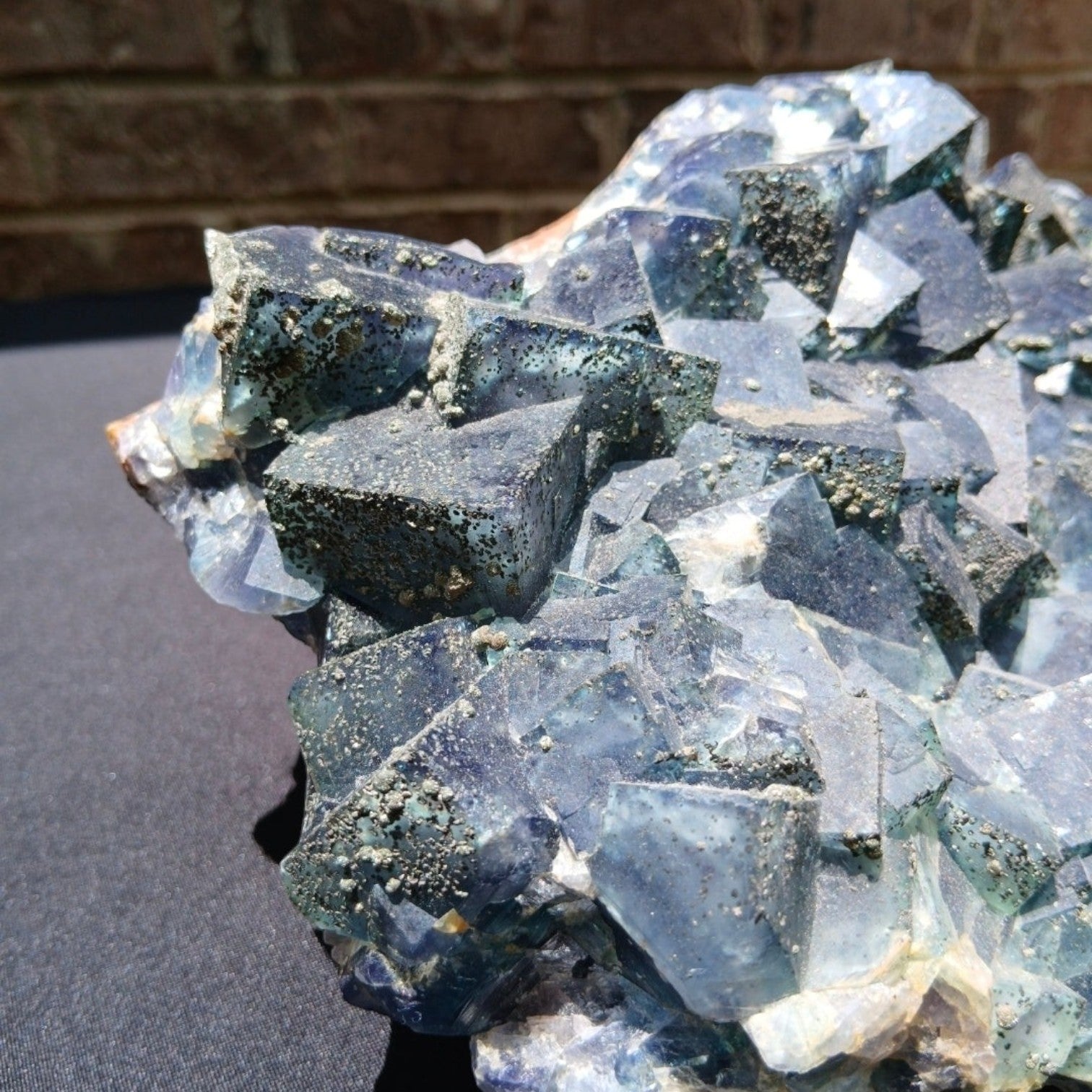 Fordite Haus: Crystals & Fordite green Superior Mine fluorite mineral specimen with pyrite dusting and cubic crystals.