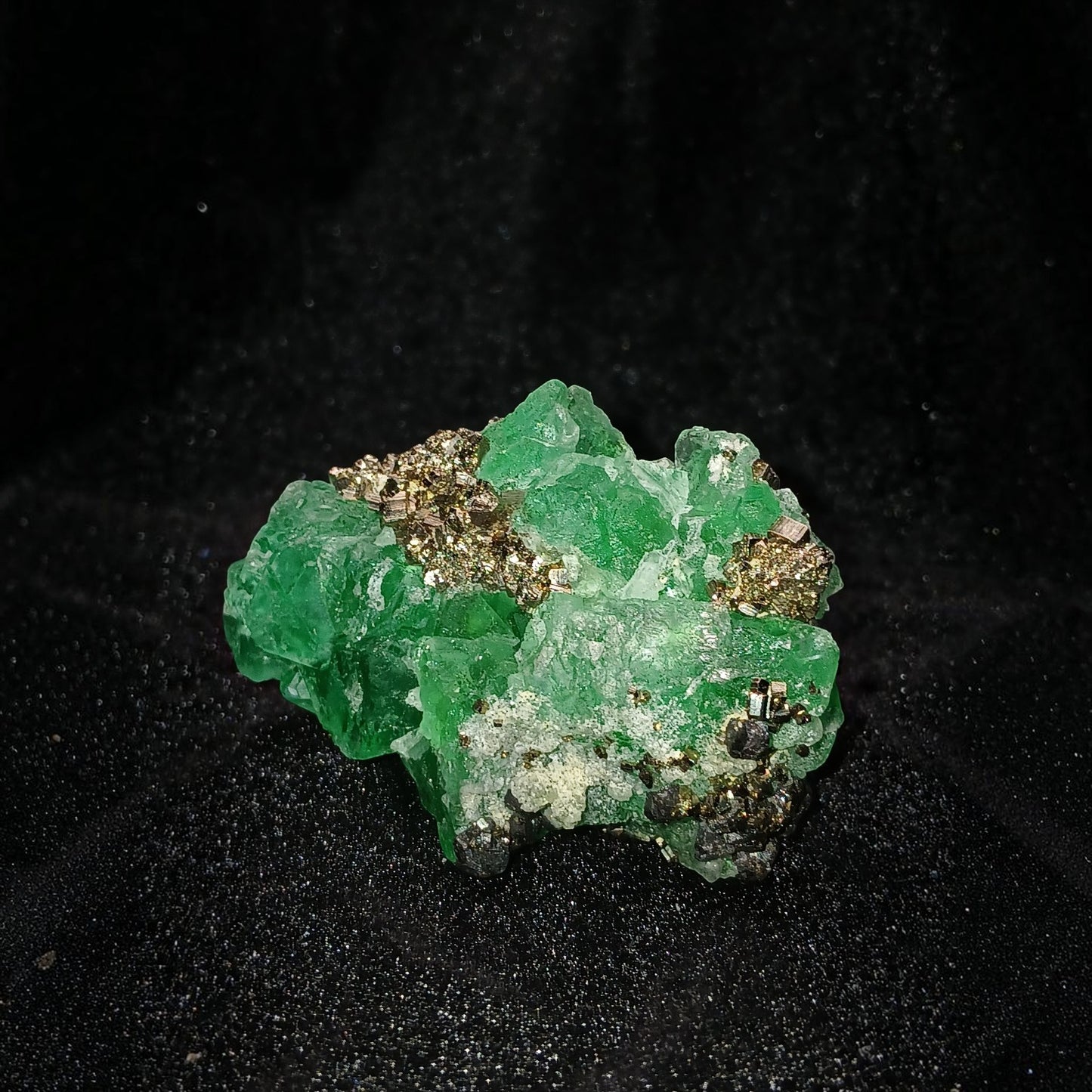 Fordite Haus: Crystals & Fordite green Milpo fluorite mineral specimen with metallic pyrite and sphalerite inclusions.