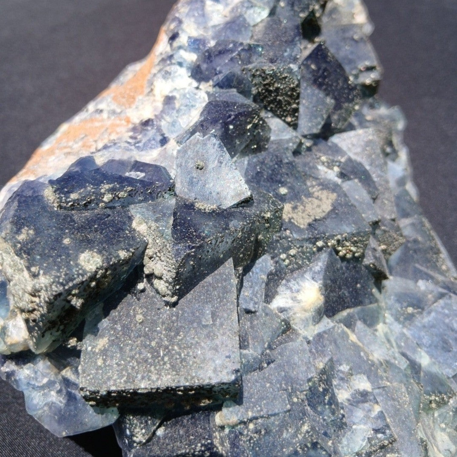 Fordite Haus: Crystals & Fordite green Superior Mine fluorite mineral specimen with pyrite dusting and crystal facets.