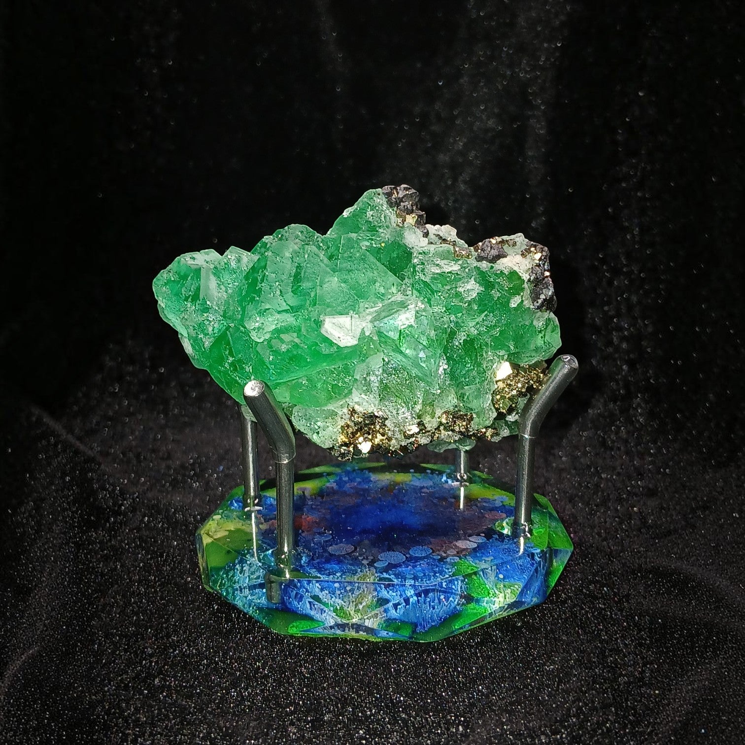 Fordite Haus: Crystals & Fordite green Milpo fluorite mineral specimen with pyrite and sphalerite on a display stand