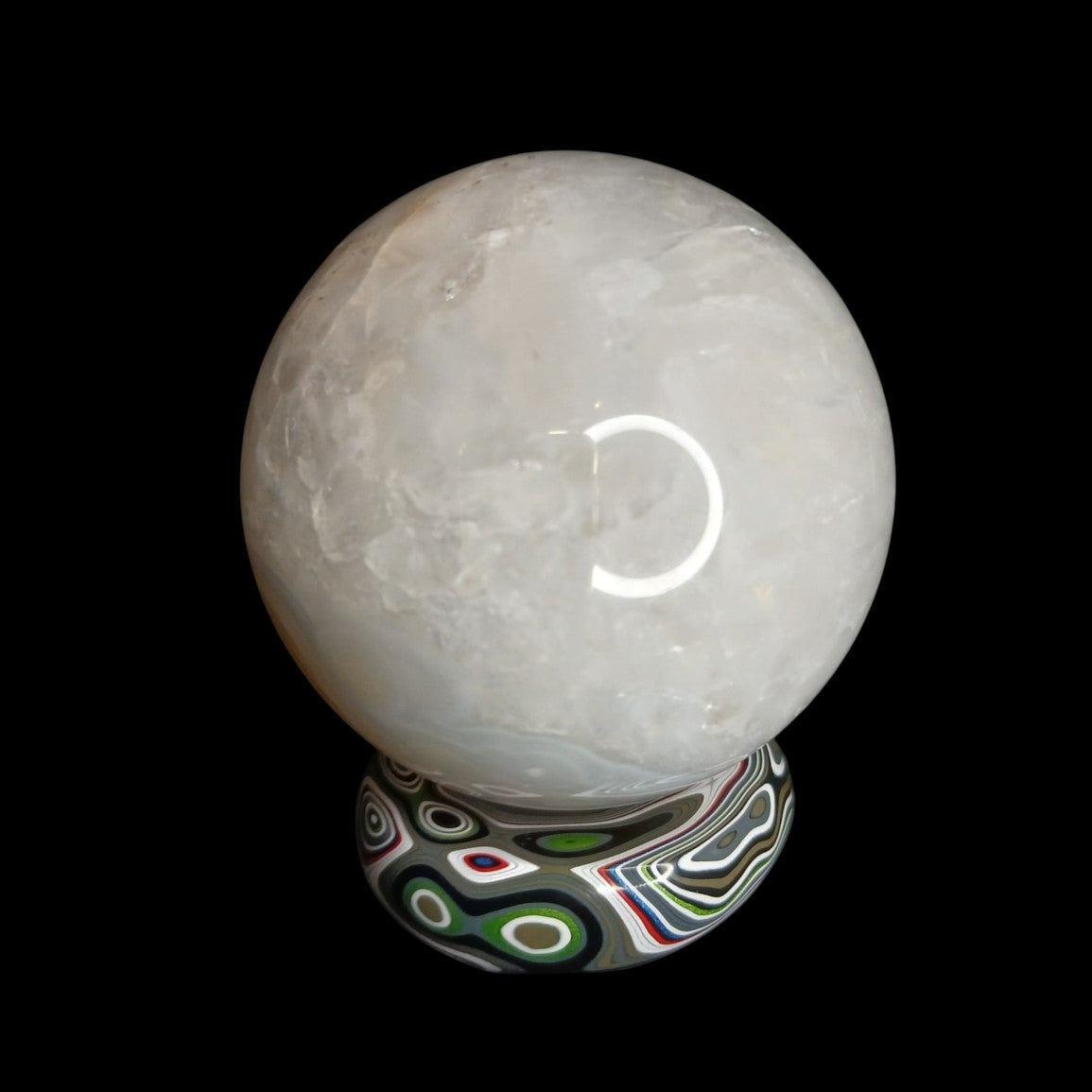 Fordite Haus: Crystals & Fordite Jeepite sphere stand featuring colorful automotive paint layers holding a crystal