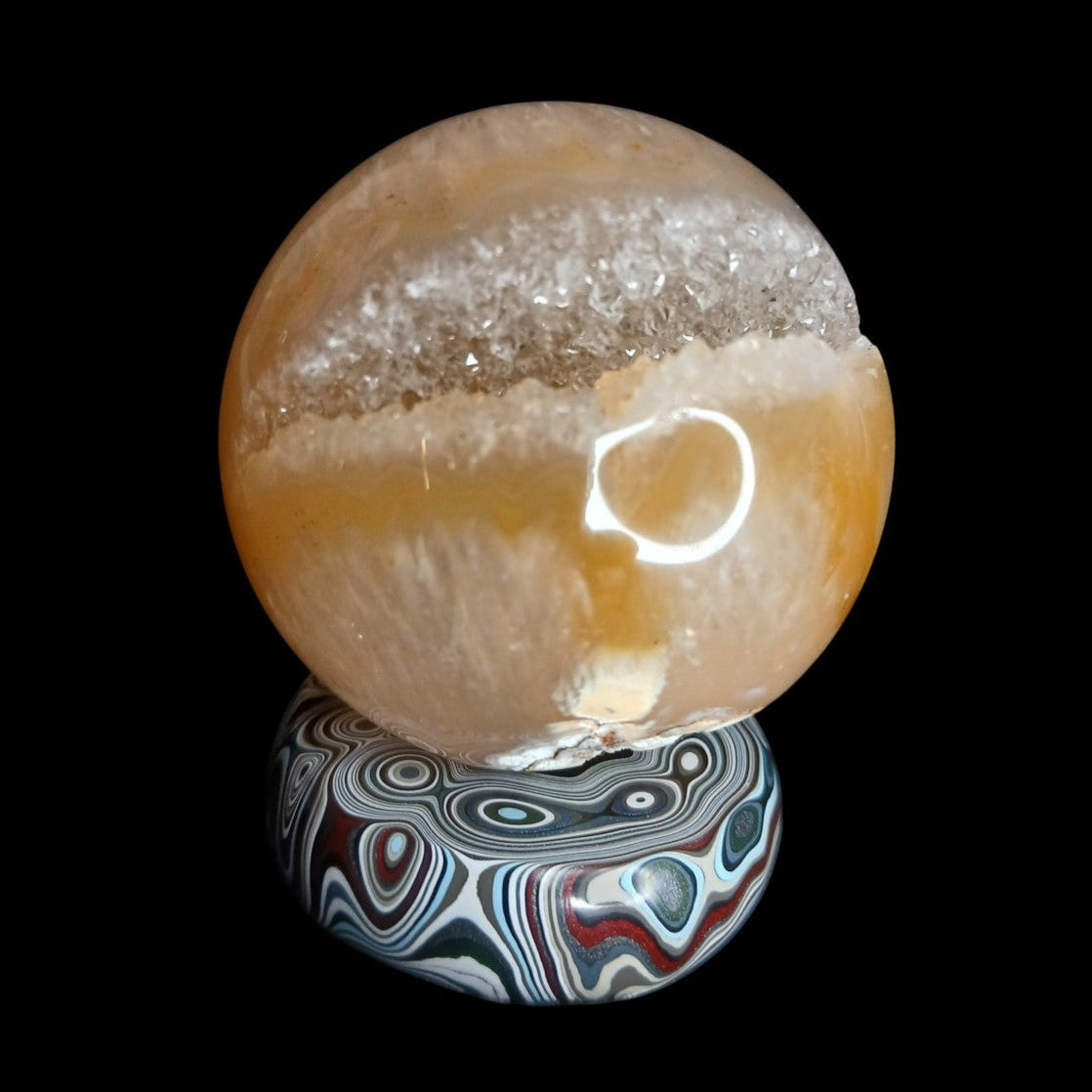 Fordite Haus: Crystals & Fordite hand-polished automotive paint mini sphere stand with colorful layered patterns
