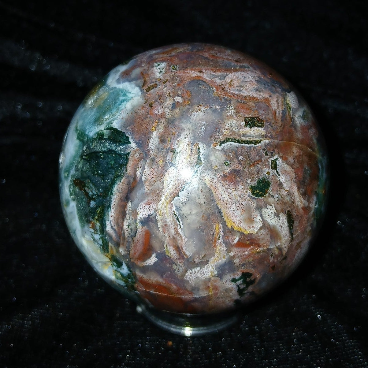 Fordite Haus: Crystals & Fordite 57.4mm Ocean Jasper sphere from Madagascar with green, brown, and white patterns.