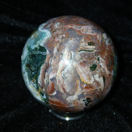 Fordite Haus: Crystals & Fordite 57.4mm Ocean Jasper sphere from Madagascar with green, brown, and white patterns.