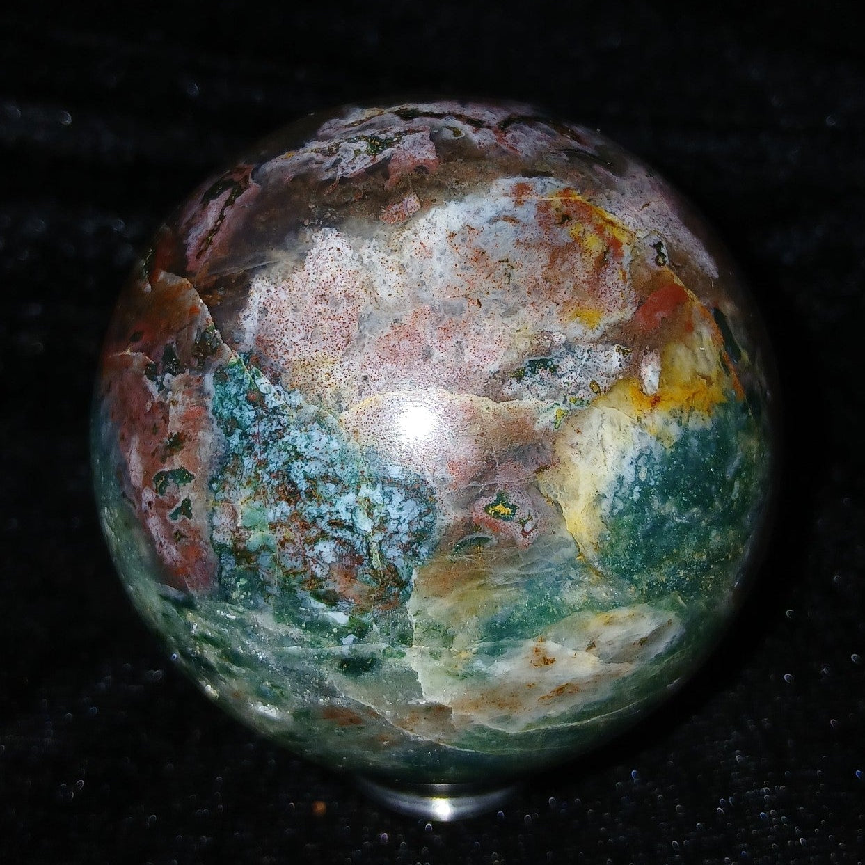 Fordite Haus: Crystals & Fordite 57.3mm polished Ocean Jasper sphere with green, red, and white earthy patterns.