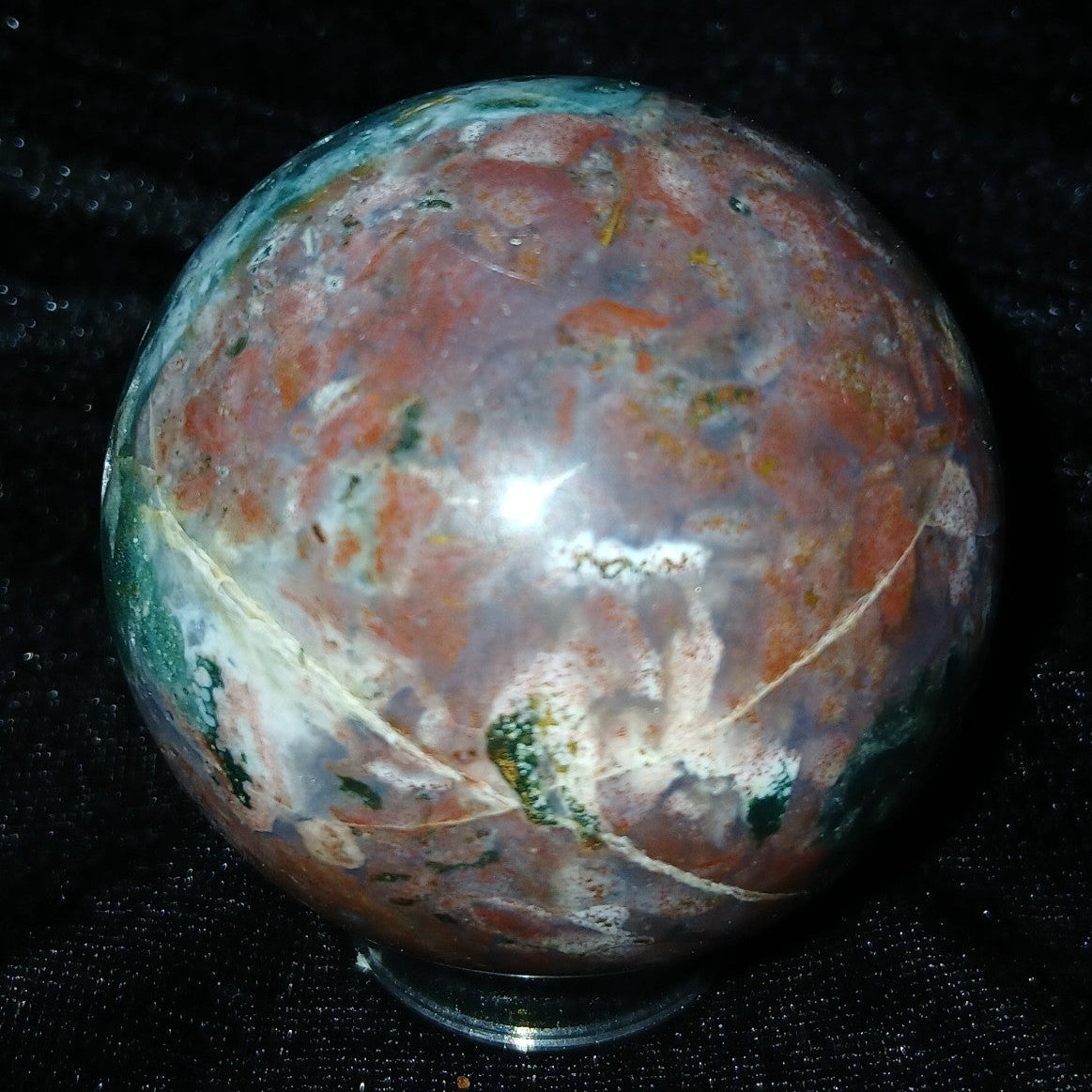 Fordite Haus: Crystals & Fordite 57.4mm polished Ocean Jasper sphere from Madagascar with green and red patterns