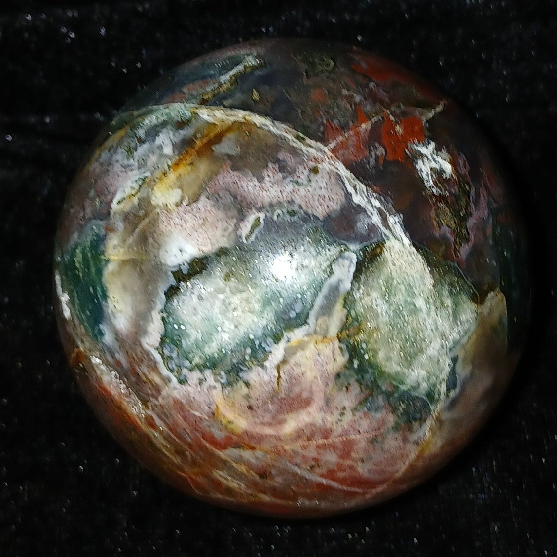 Fordite Haus: Crystals & Fordite 61mm Ocean Jasper sphere from Madagascar with green, red, and white orbicular patterns