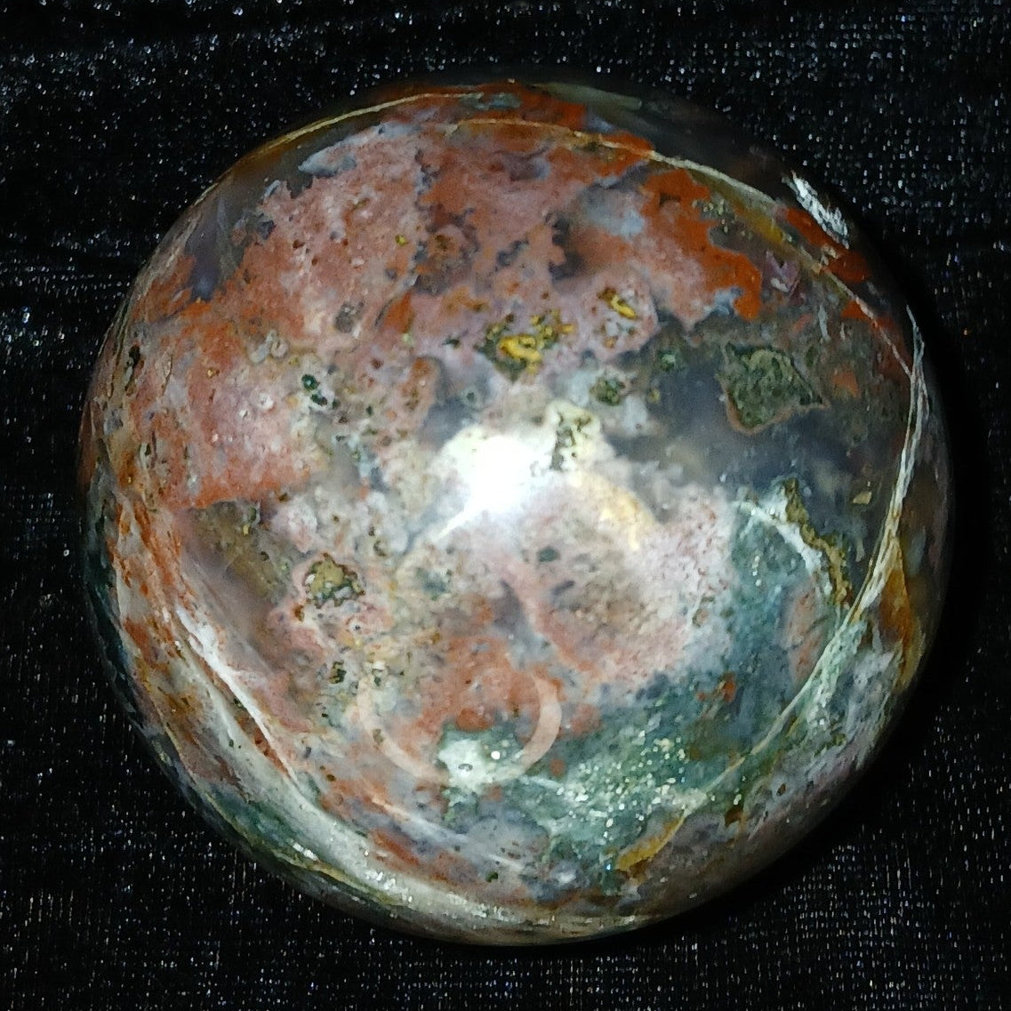 Fordite Haus: Crystals & Fordite 61mm Ocean Jasper sphere from Madagascar with multi-colored orbicular patterns.