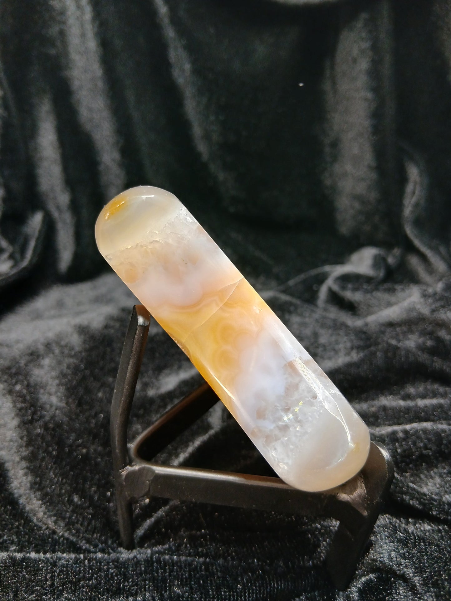 Fordite Haus: Crystals & Fordite peachy agate crescent moon carving with cream banding and translucent finish on stand