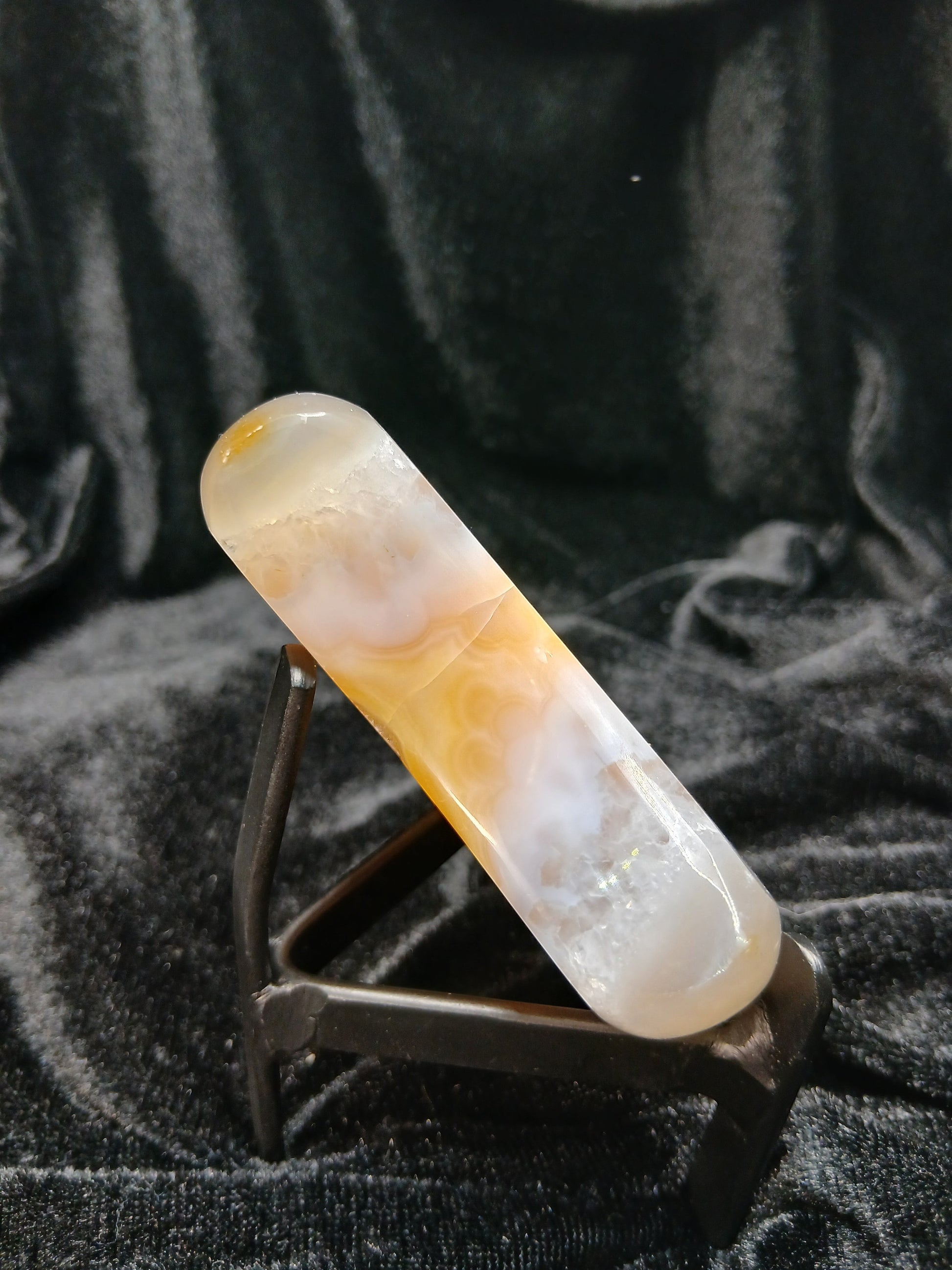 Fordite Haus: Crystals & Fordite peachy agate crescent moon carving with cream banding and translucent finish on stand