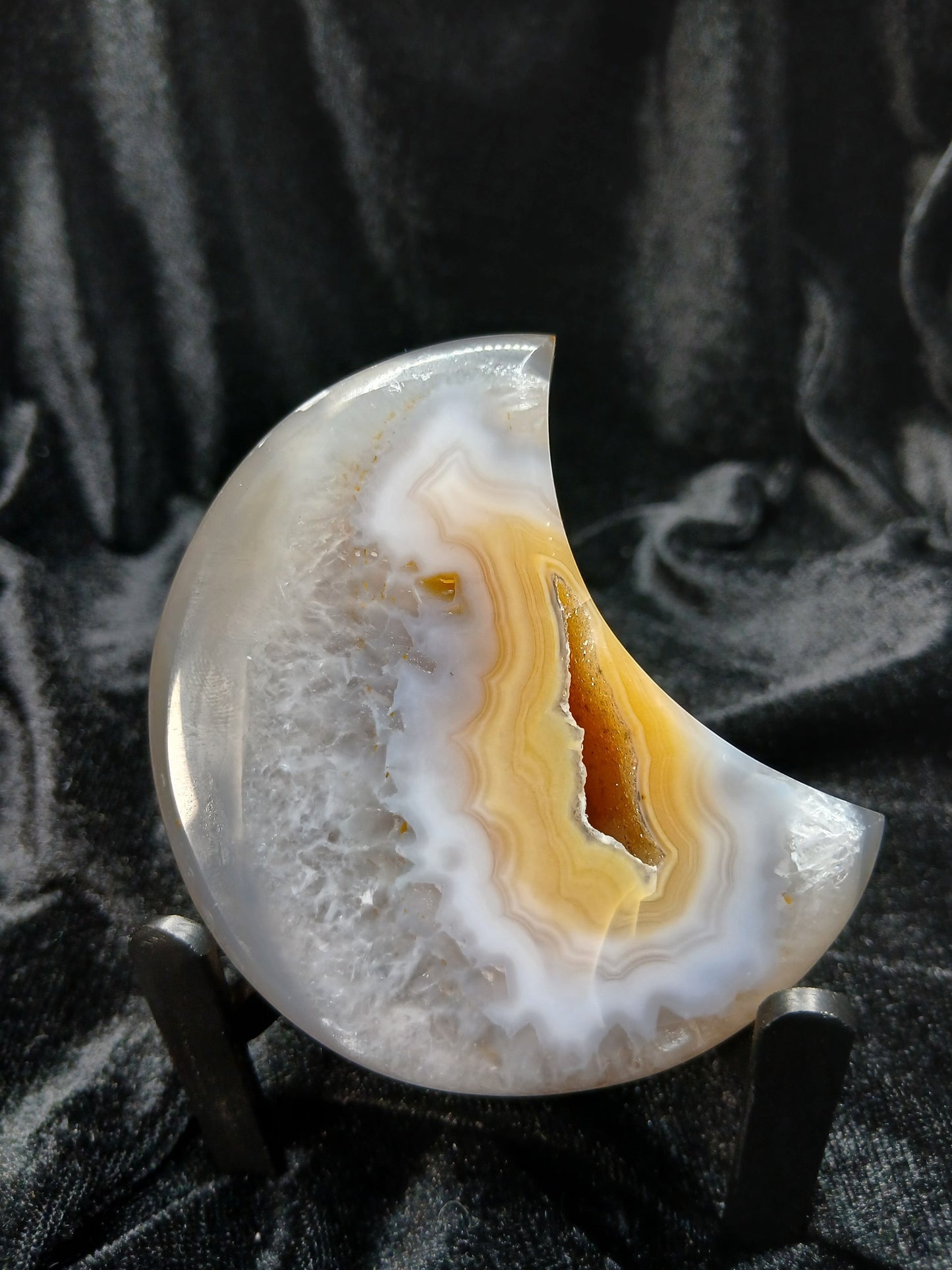 Fordite Haus: Crystals & Fordite peachy agate crescent moon carving with natural banding and translucent edges.