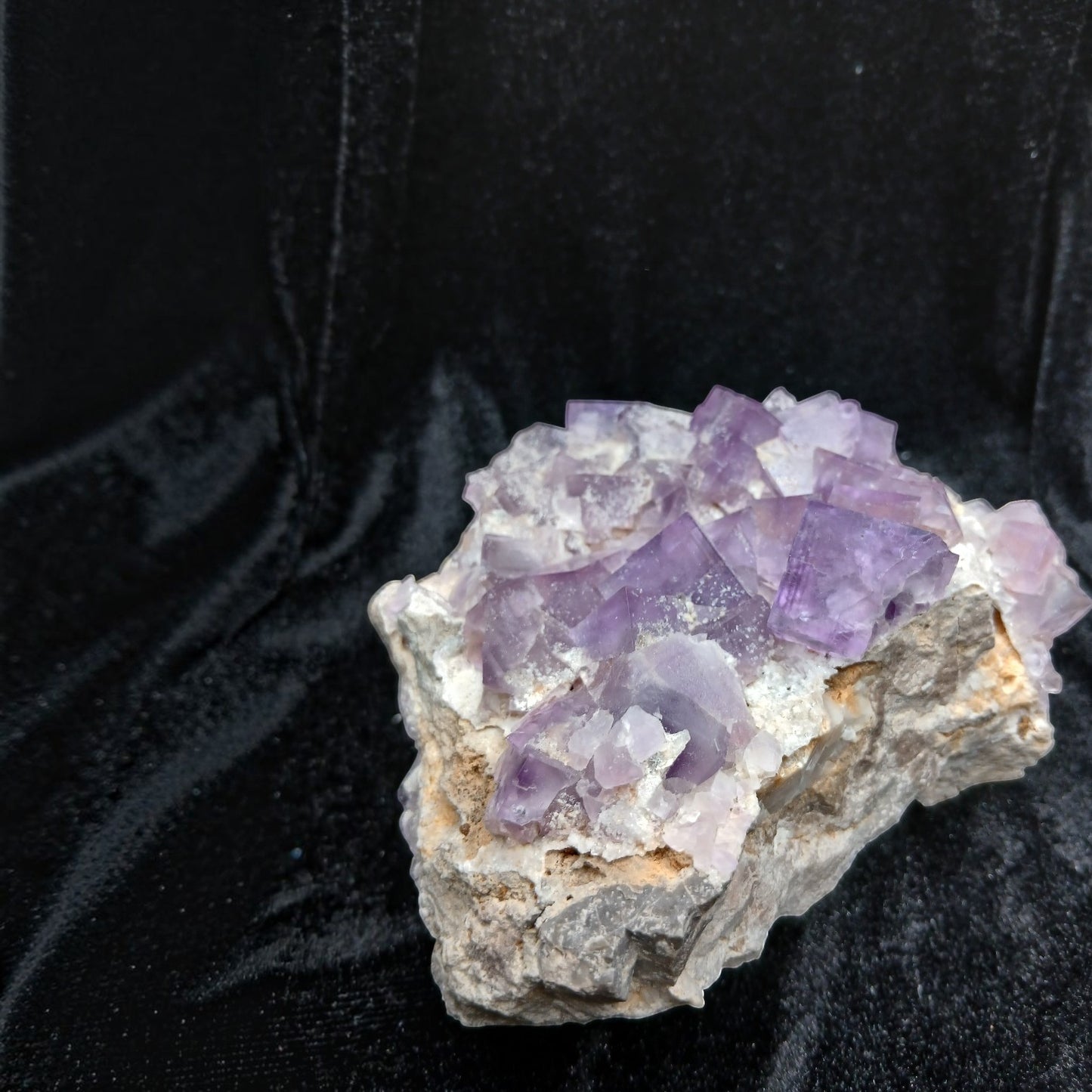 Fordite Haus: Crystals & Fordite La Viesca purple fluorite mineral specimen with cubic crystals on a dark background