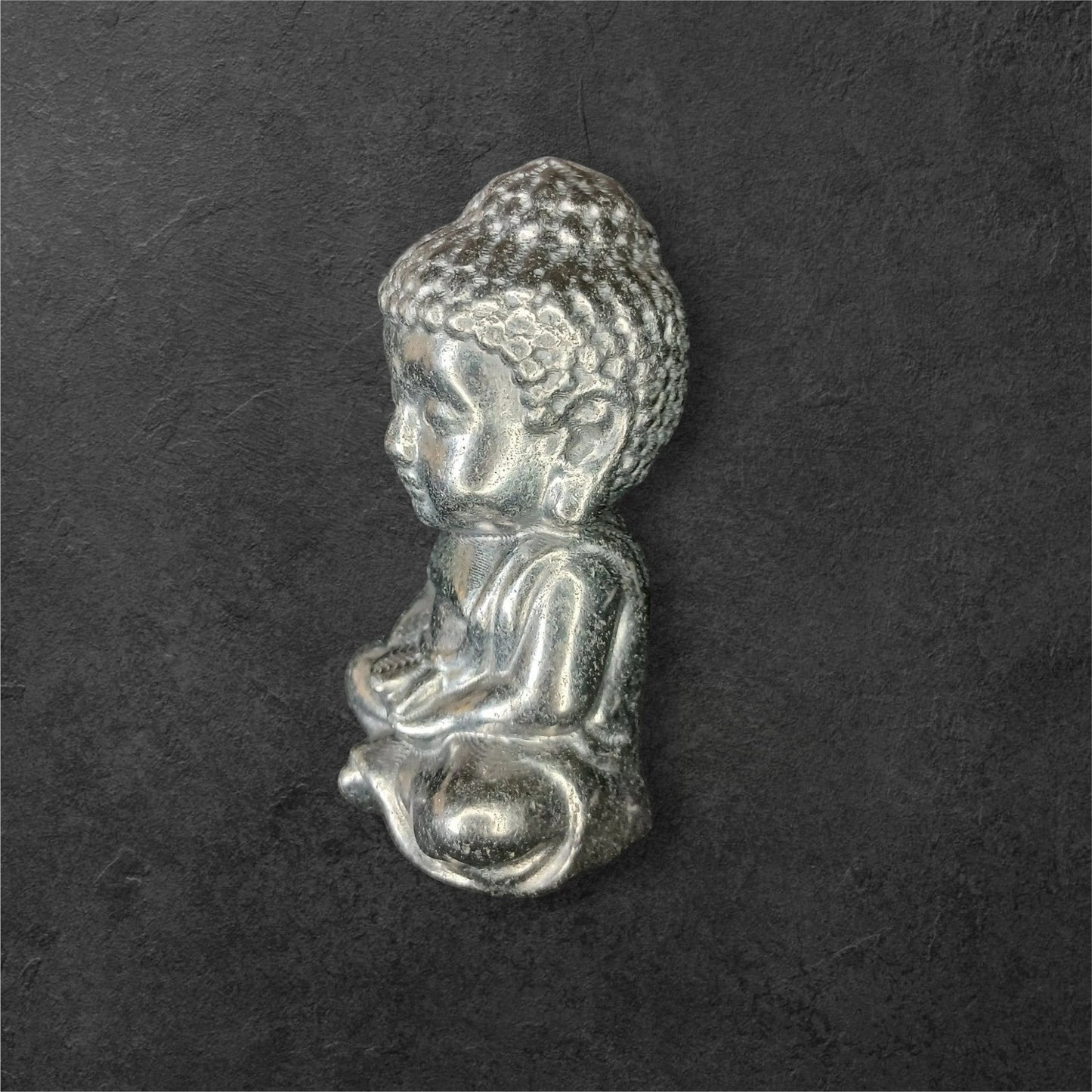 Fordite Haus: Crystals & Fordite small metallic silver meditating Buddha figurine in a seated pose