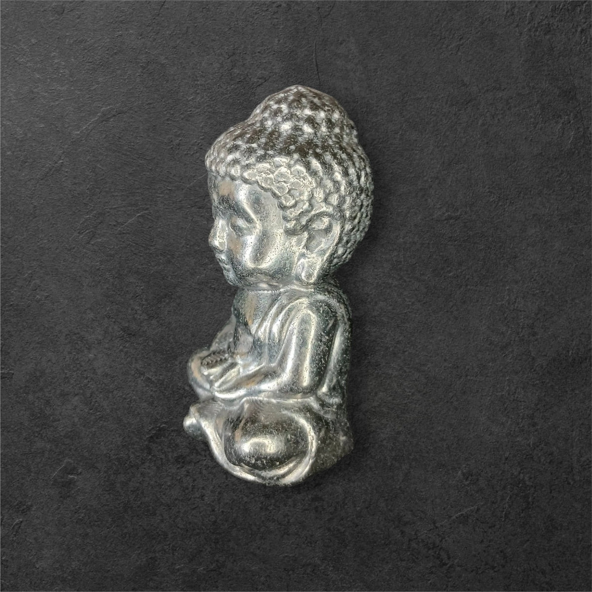 Fordite Haus: Crystals & Fordite small metallic silver meditating Buddha figurine in a seated pose