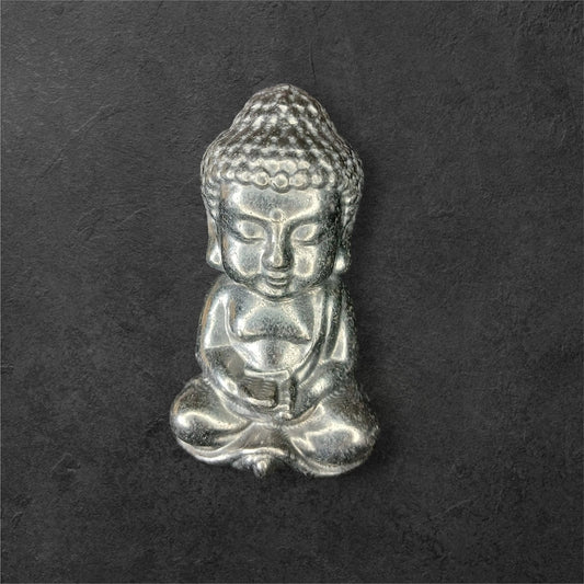 Fordite Haus: Crystals & Fordite small silver meditating Buddha figurine with intricate hair and serene expression.