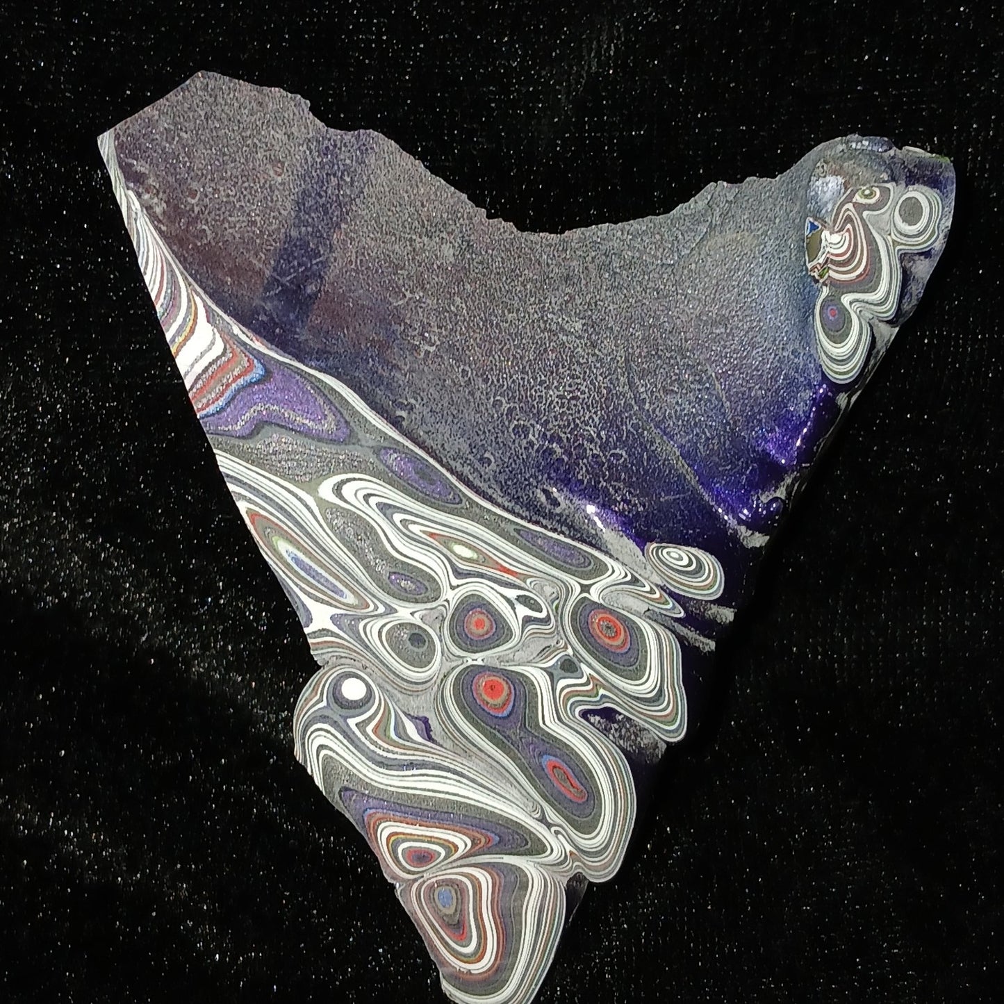Fordite Haus Jeepite slab featuring vibrant multi-colored paint layers and swirls from Jeep Wrangler factory overspray.