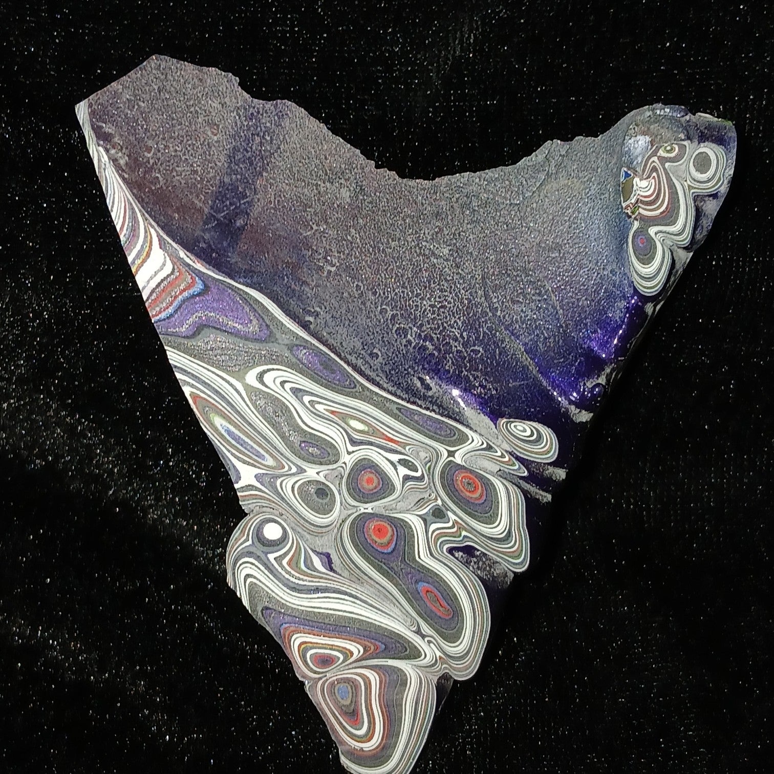 Fordite Haus Jeepite slab featuring vibrant multi-colored paint layers and swirls from Jeep Wrangler factory overspray.